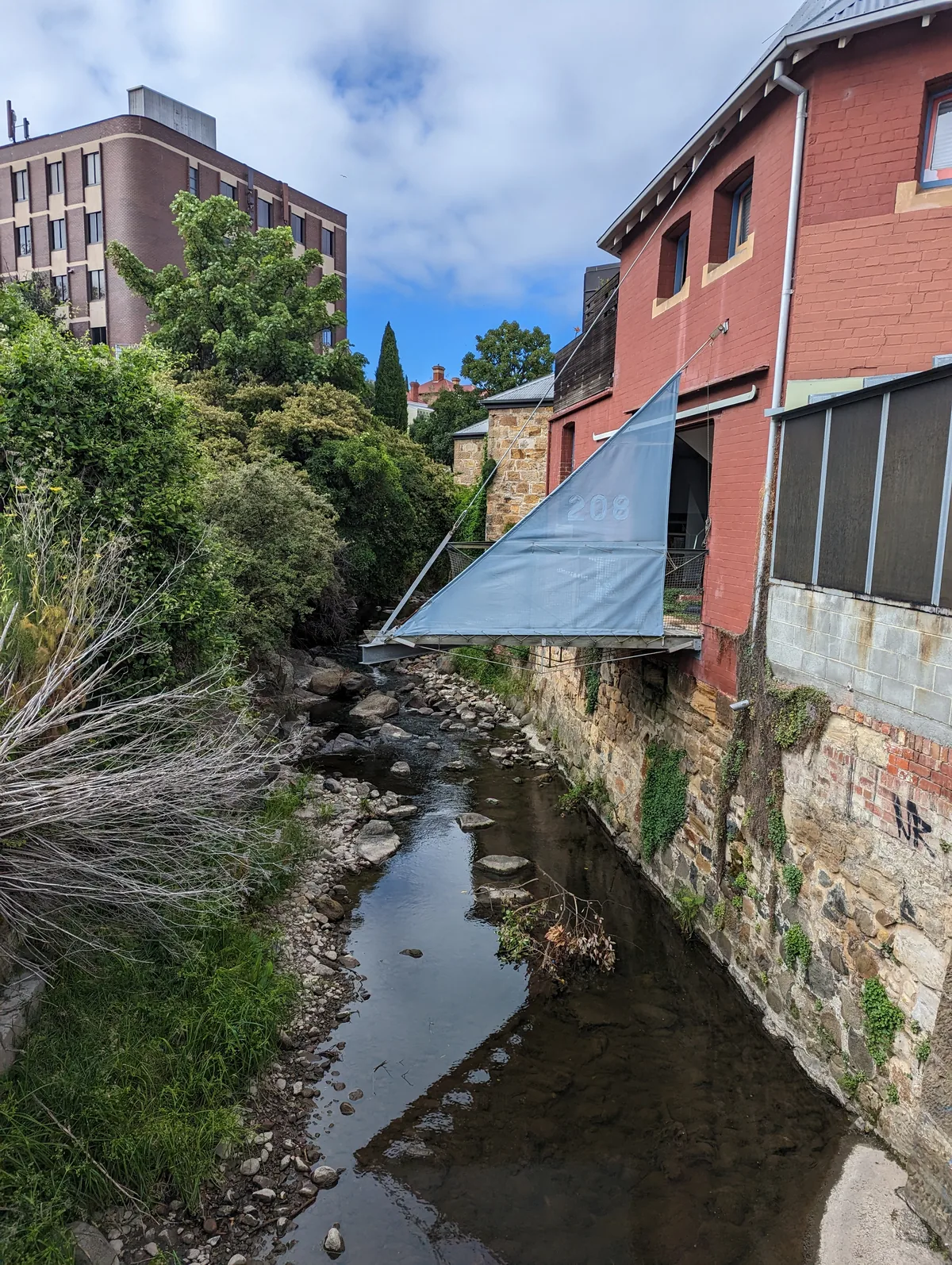 The Hobart Rivulet running between stone walls at Collins Street in central Hobart.